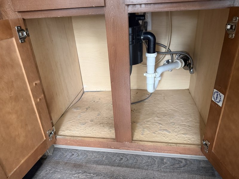 Before: under-sink kitchen cabinet with a worn, uneven base.