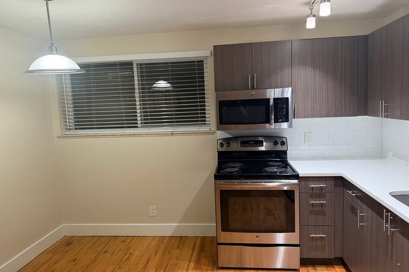 After: the same kitchen after wall painting and move-out cleaning.